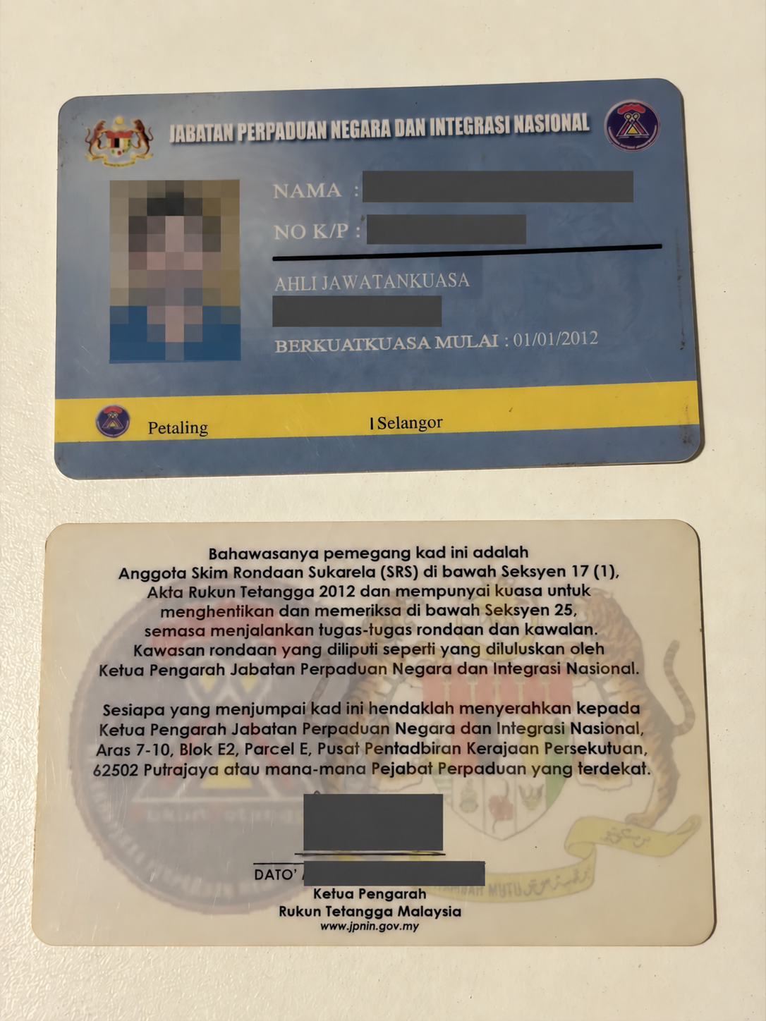 Malaysia photo ID card sample with portrait pixelated and personal details redacted